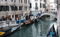 Gondolas parked along the waterway Venice.jpg